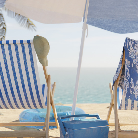 Two deck chairs, an umbrella, a float, and the sea on the horizon